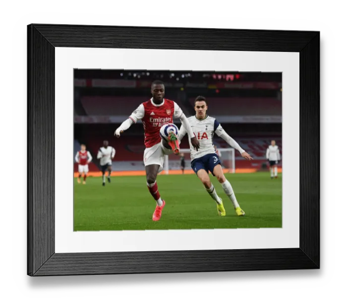 Framed Print : Arsenal vs. Tottenham: Pepe Under Pressure in Intense Premier League Clash