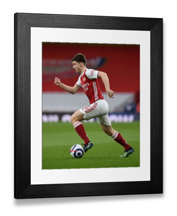 Framed Print : Arsenal's Kieran Tierney Goes Head-to-Head with Tottenham at the Emirates Stadium