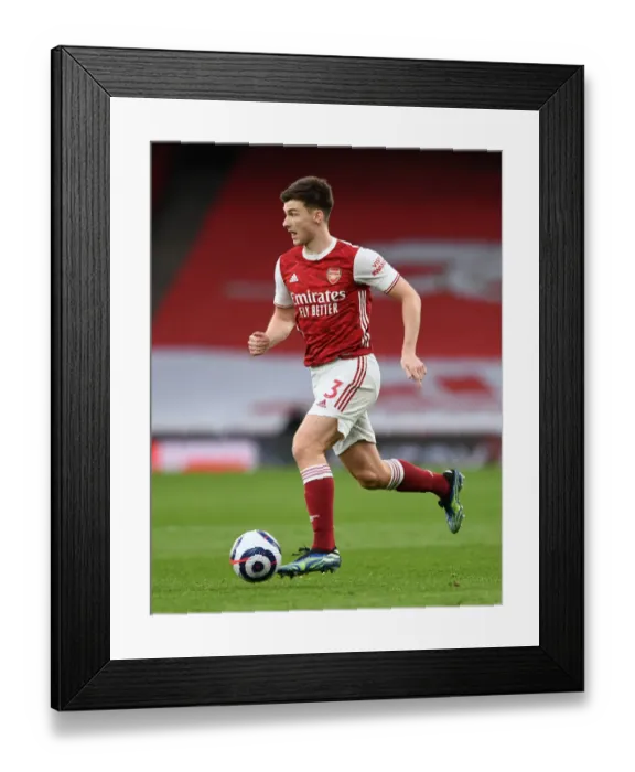 Framed Print : Arsenal's Kieran Tierney Faces Off Against Tottenham at the Emirates Stadium