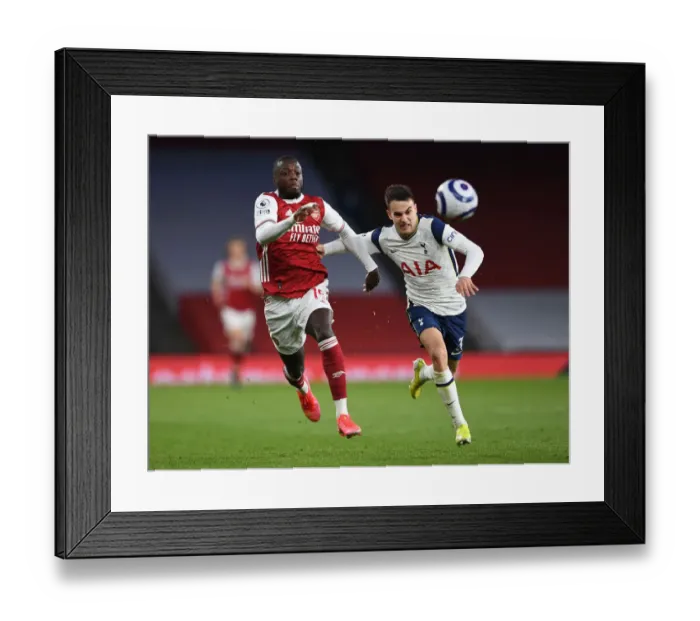 Framed Print : Arsenal vs. Tottenham: Pepe vs. Reguilon Clash in Premier League Showdown
