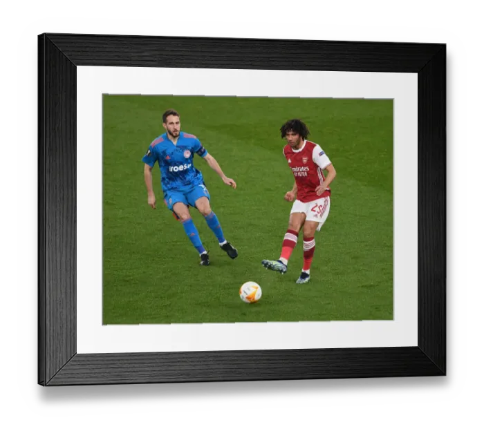 Framed Print : Arsenal vs Olympiacos: Elneny Fends Off Fortounis in Empty Europa League Clash