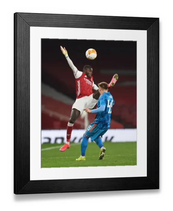 Framed Print : Arsenal vs Olympiacos: Pepe Faces Off in Empty Europa League Clash