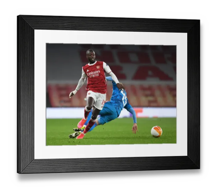 Framed Print : Arsenal's Nicolas Pepe Scores Past Olympiacos in Empty Emirates Stadium - UEFA Europa League Round of 16 Framed Print : Arsenal's Nicolas Pepe Scores Past Olympiacos in Empty Emirates Stadium - UEFA Europa League Round of 16