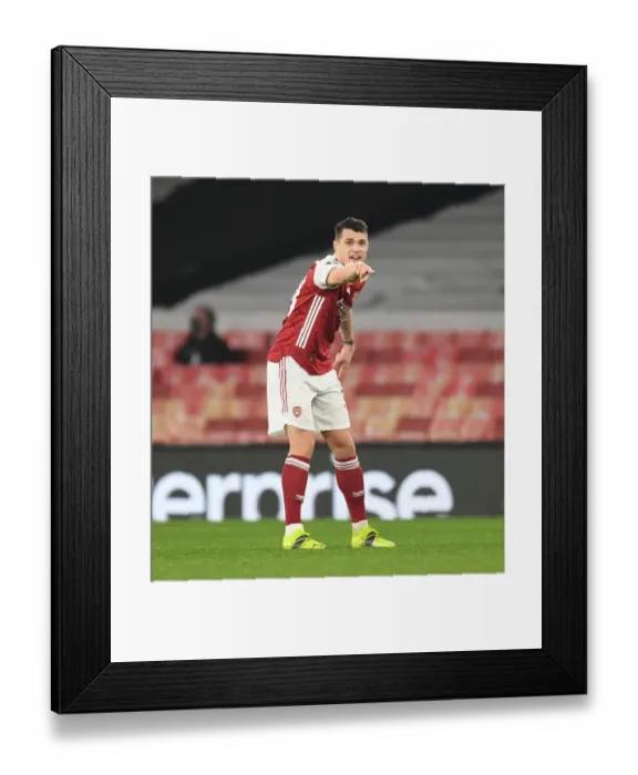 Framed Print : Behind Closed Doors: Granit Xhaka in UEFA Europa League Action for Arsenal Against Olympiacos