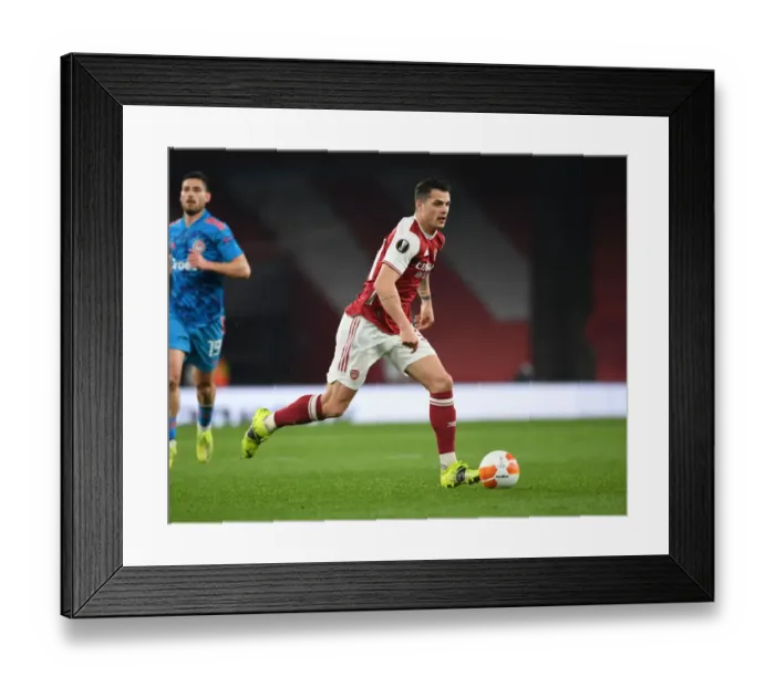 Framed Print : Arsenal's Granit Xhaka in Empty Emirates: UEFA Europa League Clash Against Olympiacos