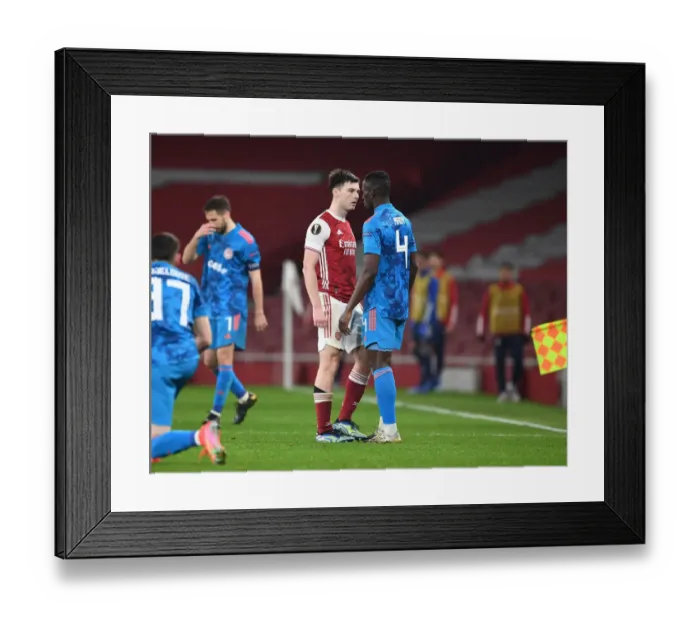 Framed Print : Arsenal's Tierney Goes Head-to-Head with Camara in Empty Europa League Clash, London, 2021