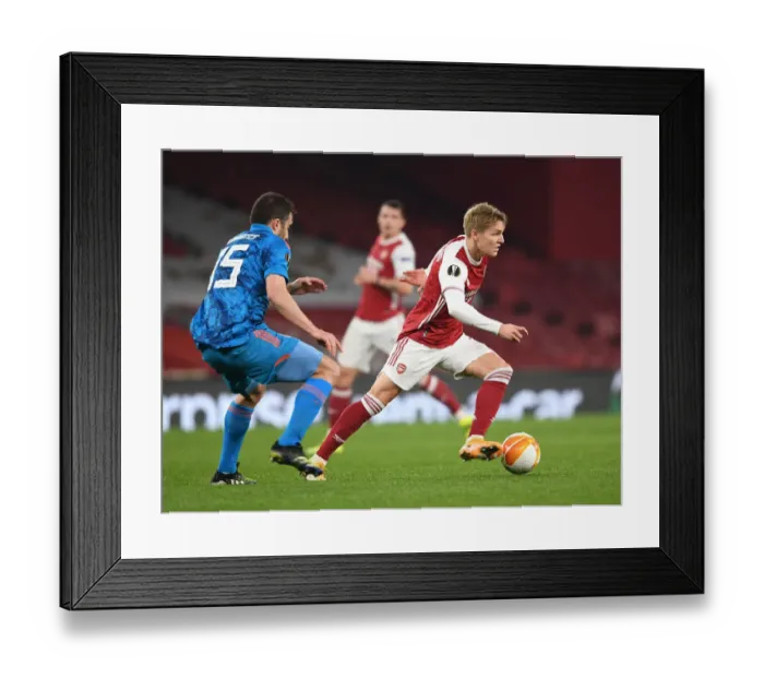 Framed Print : Arsenal vs Olympiacos: Clash of Martin Odegaard and Sokratis in Empty Europa League Match, London, 2021 Framed Print : Arsenal vs Olympiacos: Clash of Martin Odegaard and Sokratis in Empty Europa League Match, London, 2021