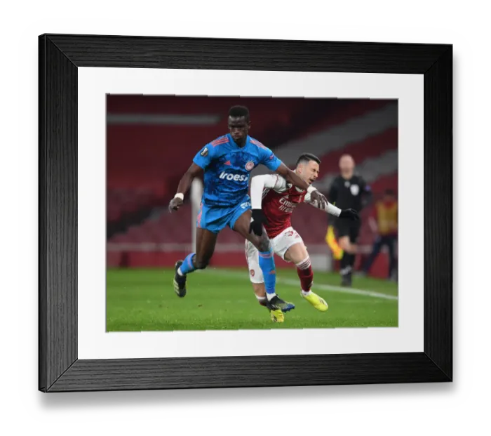 Framed Print : Arsenal's Martinelli Fouls Olympiacos Ba in Empty Europa League Clash (2020-21)