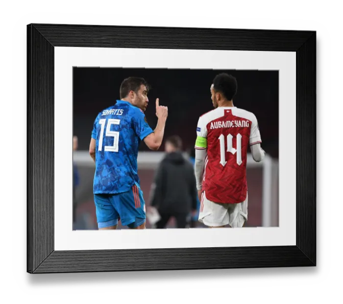 Framed Print : Arsenal vs Olympiacos: Aubameyang and Sokratis Clash in Empty Europa League Match Framed Print : Arsenal vs Olympiacos: Aubameyang and Sokratis Clash in Empty Europa League Match