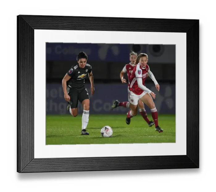 Framed Print : Great attempt! Here are a few alternative title suggestions for the image: 1. FA WSL Rivalry: Malin Gut vs Jess Sigsworth - Arsenal Women vs Manchester United Women in Empty Stands 2. Empty Meadow Park: Malin Gut and Jess Sigsworth Battle it Out in the FA WSL 3. The Silent Showdown: Arsenal Women vs Manchester United Women - Malin Gut vs Jess Sigsworth in an Empty Stadium 4. FA WSL Clash: Malin Gut and Jess Sigsworth Go Head to Head in an Empty Meadow Park 5. Arsenal Women vs Manchester United Women: Malin Gut and Jess Sigsworth Face Off in an Empty Stadium (FA WSL 2020-21)