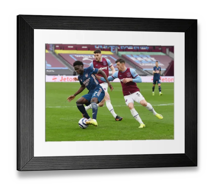 Framed Print : Bukayo Saka vs Aaron Cresswell: A Battle at London Stadium - Arsenal vs West Ham United, Premier League 2021