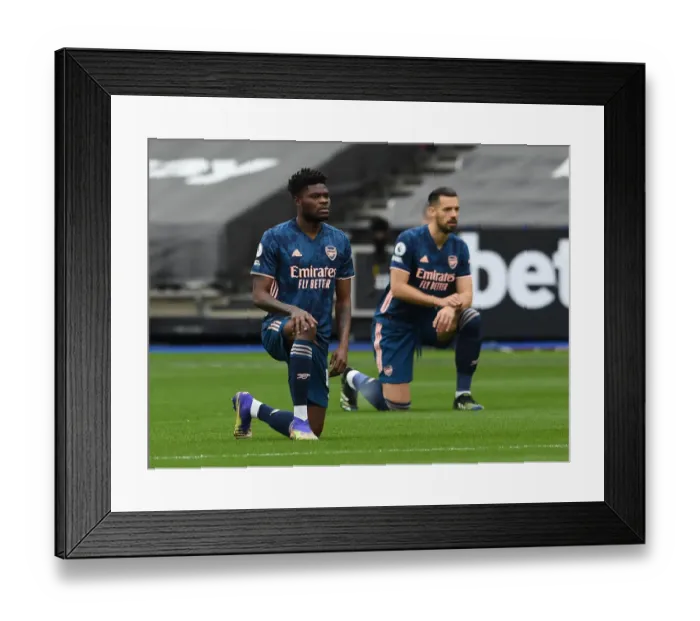 Framed Print : Thomas Partey Kneels: Arsenal vs. West Ham United in Premier League Action Framed Print : Thomas Partey Kneels: Arsenal vs. West Ham United in Premier League Action