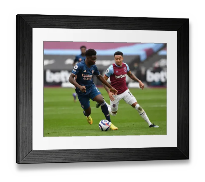 Framed Print : Saka vs Lingard: Intense Battle in West Ham United vs Arsenal Premier League Clash