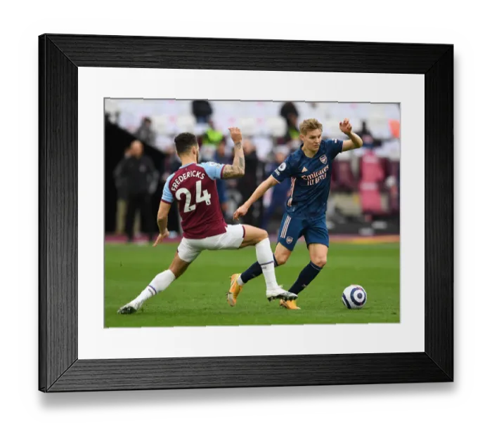 Framed Print : Arsenal's Martin Odegaard Outmaneuvers West Ham's Ryan Fredericks in Premier League Clash