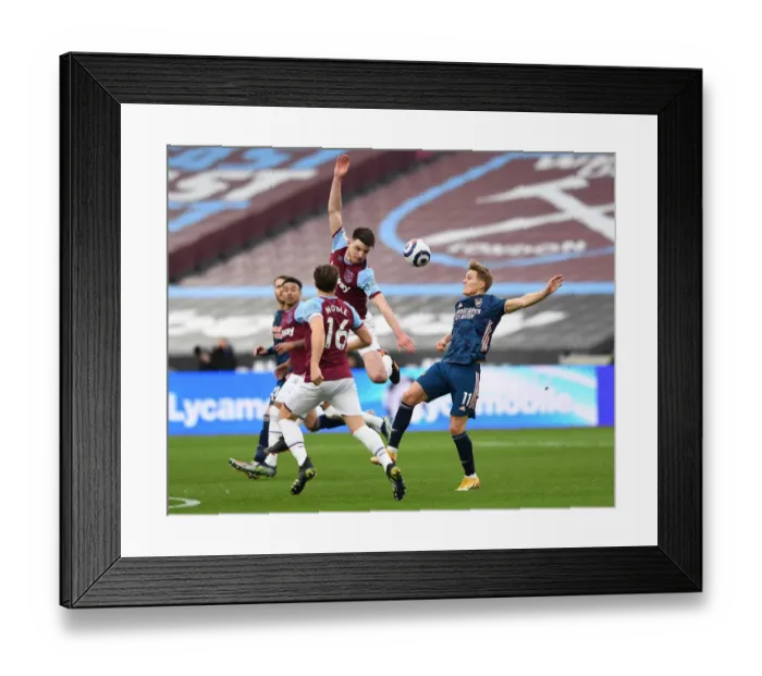Framed Print : Odegaard vs Rice: Intense Battle in West Ham vs Arsenal Premier League Clash