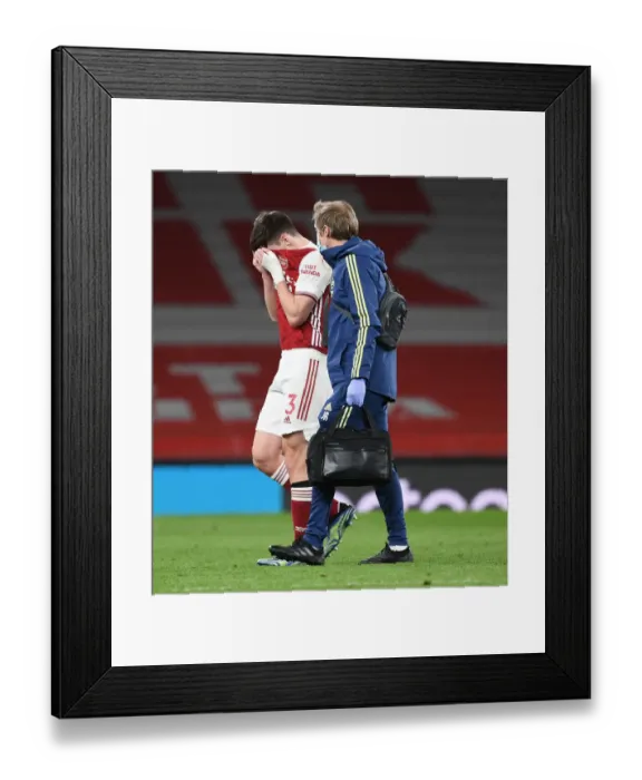 Framed Print : Arsenal's Kieran Tierney Exits with Injury as Arsenal v Liverpool Plays Behind Closed Doors (2020-21)