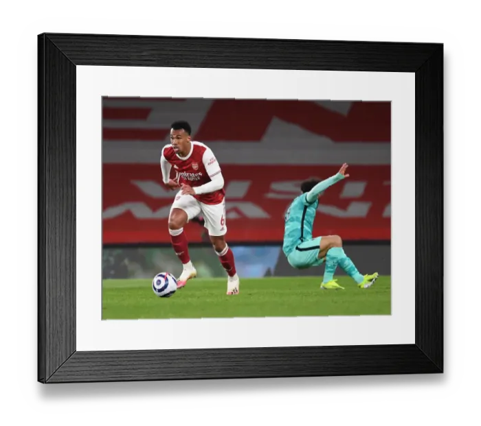 Framed Print : Gabriel vs. Salah: Arsenal vs. Liverpool, Premier League Clash Amidst Empty Stands (2020-21) Framed Print : Gabriel vs. Salah: Arsenal vs. Liverpool, Premier League Clash Amidst Empty Stands (2020-21)