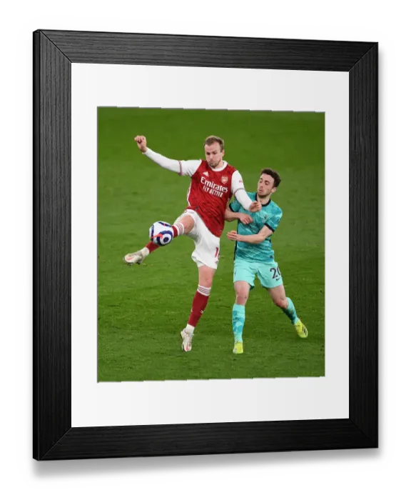 Framed Print : Arsenal vs. Liverpool: Holding Clears Under Pressure in Intense Premier League Clash Framed Print : Arsenal vs. Liverpool: Holding Clears Under Pressure in Intense Premier League Clash