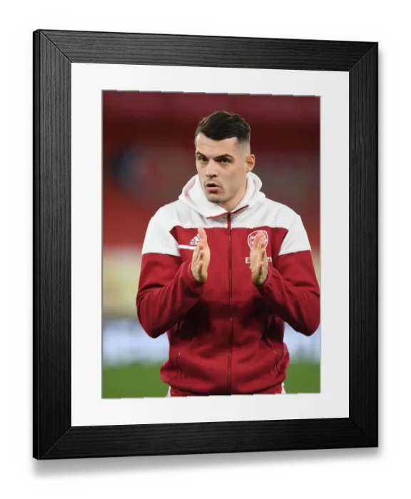 Framed Print : Granit Xhaka Gears Up: Arsenal's Silent Warrior at Empty Emirates for Slavia Praha - UEFA Europa League Quarterfinal
