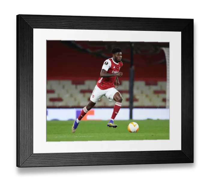 Framed Print : Thomas Partey: The Solo Warrior in Empty Emirates Stadium - Arsenal's UEFA Europa League Battle Framed Print : Thomas Partey: The Solo Warrior in Empty Emirates Stadium - Arsenal's UEFA Europa League Battle
