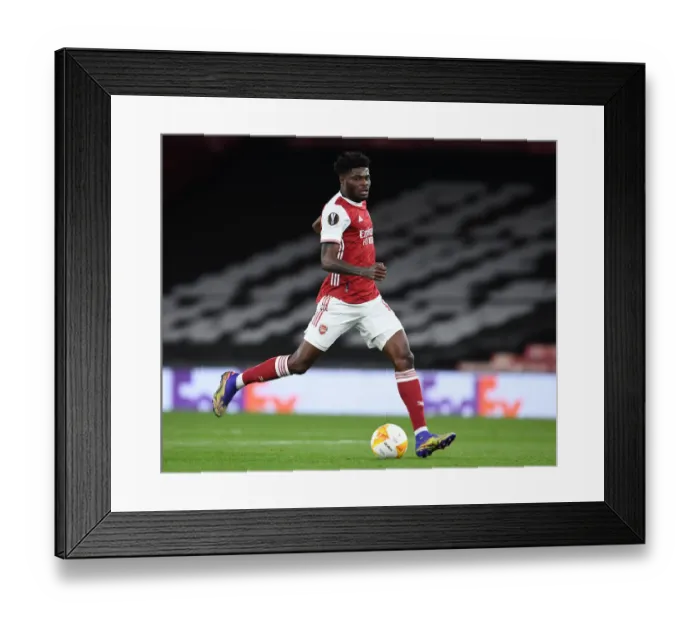 Framed Print : Thomas Partey's Quiet Battle: Arsenal's UEFA Europa League Clash Against Slavia Praha at Empty Emirates Stadium Framed Print : Thomas Partey's Quiet Battle: Arsenal's UEFA Europa League Clash Against Slavia Praha at Empty Emirates Stadium