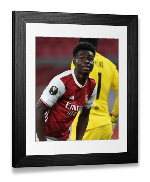 Framed Print : Lone Warrior: Bukayo Saka's Europa League Battle at Empty Emirates