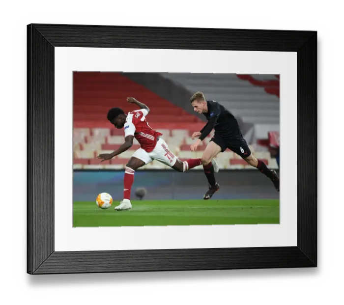 Framed Print : Arsenal vs Slavia Praha: Bukayo Saka Tripped in UEFA Europa League Quarterfinal Amid Empty Stands Framed Print : Arsenal vs Slavia Praha: Bukayo Saka Tripped in UEFA Europa League Quarterfinal Amid Empty Stands