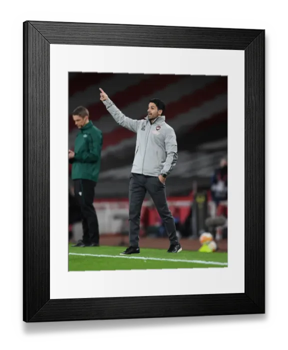 Framed Print : Mikel Arteta Leads Empty Emirates: Arsenal vs Slavia Praha in UEFA Europa League Quarterfinal