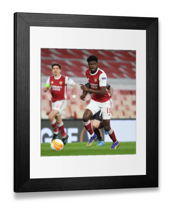 Framed Print : Thomas Partey Alone: Arsenal's Empty Emirates Stadium in UEFA Europa League Quarterfinal vs Slavia Praha Framed Print : Thomas Partey Alone: Arsenal's Empty Emirates Stadium in UEFA Europa League Quarterfinal vs Slavia Praha