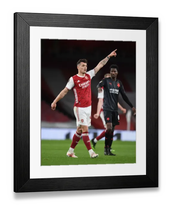 Framed Print : Arsenal's Granit Xhaka in Empty Emirates: UEFA Europa League Quarterfinal vs Slavia Praha