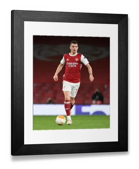 Framed Print : Granit Xhaka at Empty Emirates: Arsenal's Quarterfinal Battle against Slavia Praha in UEFA Europa League Amidst Pandemic Restrictions Framed Print : Granit Xhaka at Empty Emirates: Arsenal's Quarterfinal Battle against Slavia Praha in UEFA Europa League Amidst Pandemic Restrictions
