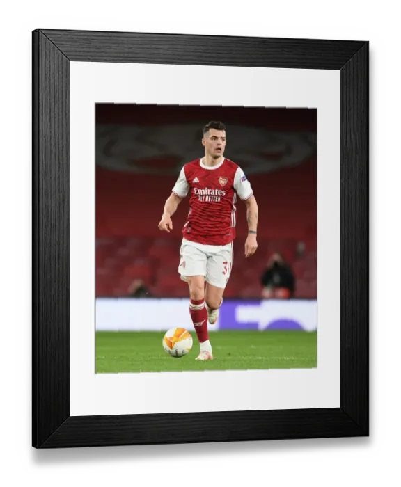 Framed Print : Arsenal vs Slavia Praha: Granit Xhaka in UEFA Europa League Quarterfinal at Empty Emirates Stadium