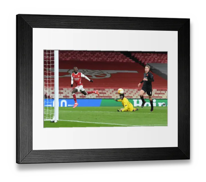 Framed Print : Arsenal's Nicolas Pepe Scores Chip Against Slavia Praha in Empty Europa League Quarterfinal Framed Print : Arsenal's Nicolas Pepe Scores Chip Against Slavia Praha in Empty Europa League Quarterfinal