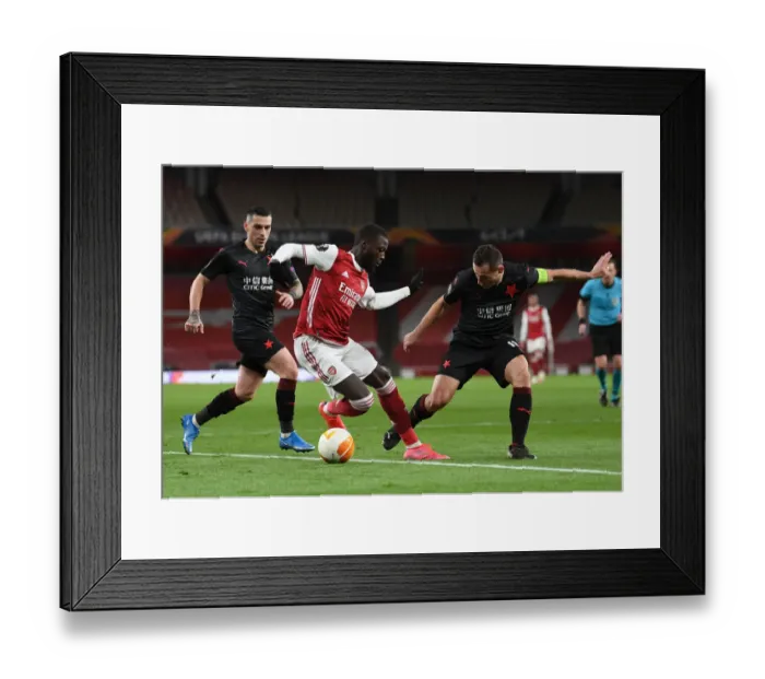 Framed Print : Arsenal's Nicolas Pepe Goes Head-to-Head with Slavia Praha in Empty Emirates Stadium - Europa League Quarterfinal