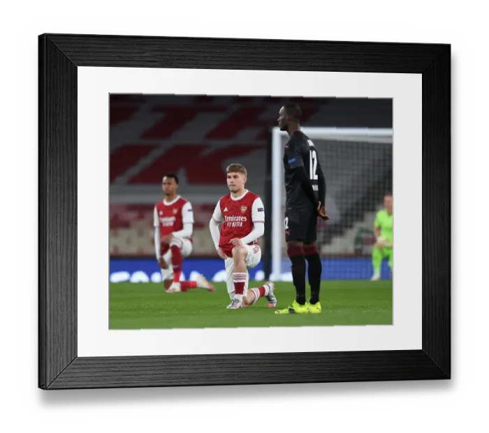 Framed Print : Arsenal's Emile Smith Rowe Kneels at Empty Emirates Stadium in Europa League Quarterfinal vs Slavia Praha Framed Print : Arsenal's Emile Smith Rowe Kneels at Empty Emirates Stadium in Europa League Quarterfinal vs Slavia Praha
