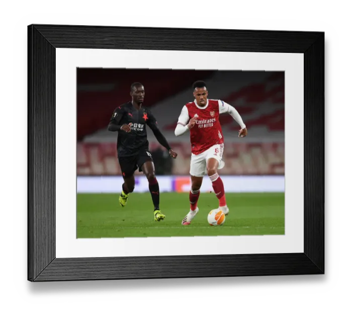Framed Print : Arsenal vs Slavia Prague: Gabriel Magalhaes Clash in Empty Europa League Quarterfinal