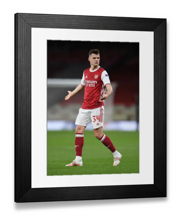 Framed Print : Arsenal's Xhaka at Empty Emirates: Arsenal vs Slavia Prague in UEFA Europa League Amid Coronavirus Restrictions