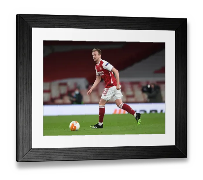 Framed Print : Arsenal's Rob Holding Focuses Amid Empty Emirates Stadium: Arsenal vs Slavia Praha, UEFA Europa League Quarterfinal (2021) Framed Print : Arsenal's Rob Holding Focuses Amid Empty Emirates Stadium: Arsenal vs Slavia Praha, UEFA Europa League Quarterfinal (2021)