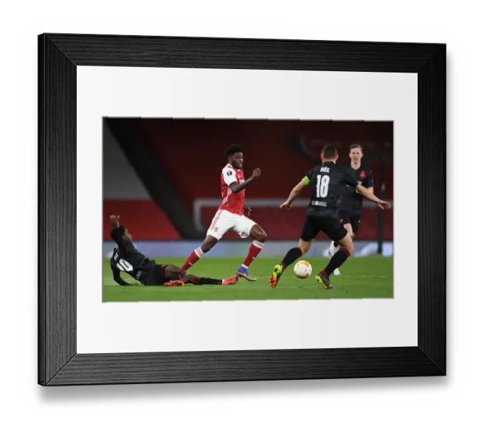 Framed Print : Thomas Partey's Quiet Battle: Arsenal's UEFA Europa League Quarterfinal at Empty Emirates Stadium Framed Print : Thomas Partey's Quiet Battle: Arsenal's UEFA Europa League Quarterfinal at Empty Emirates Stadium