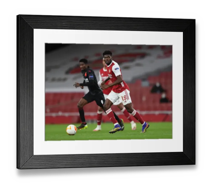 Framed Print : Silent Warrior Partey: Arsenal's Lone Battle in Empty Emirates Stadium vs Slavia Praha - UEFA Europa League Quarterfinal