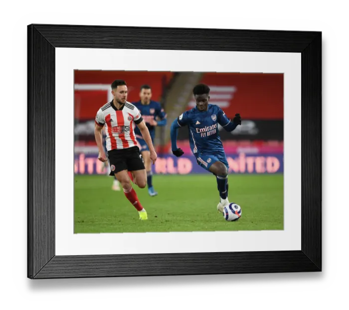 Framed Print : Arsenal's Bukayo Saka Outwits Sheffield United's George Baldock in Empty Bramall Lane