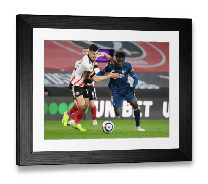 Framed Print : Bukayo Saka Darts Past Sheffield United's John Egan in Empty Bramall Lane - Arsenal vs Sheffield United, Premier League 2020-21
