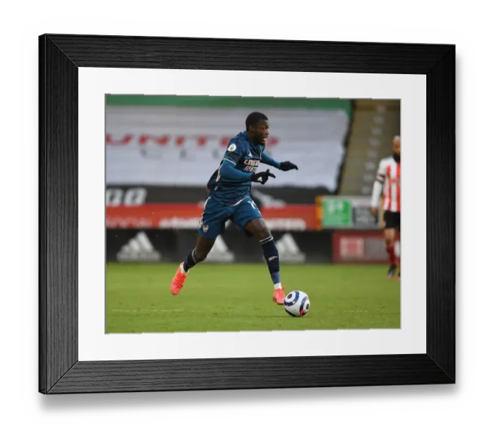 Framed Print : Empty Bramall Lane: Nicolas Pepe of Arsenal in Premier League Clash Amidst COVID-19 Restrictions Framed Print : Empty Bramall Lane: Nicolas Pepe of Arsenal in Premier League Clash Amidst COVID-19 Restrictions