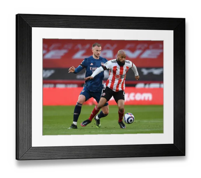 Framed Print : Arsenal's Rob Holding Shuts Down Sheffield United's David McGoldrick in Premier League Clash