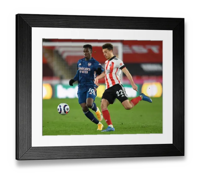 Framed Print : Arsenal's Eddie Nketiah Faces Off Against Sheffield United's Ethan Ampadu in Premier League Clash