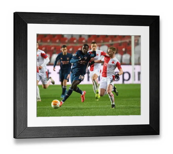 Framed Print : Arsenal's Nicolas Pepe Breaks Past Slavia Praha's Petr Sevcik in UEFA Europa League Quarterfinal Match in Prague