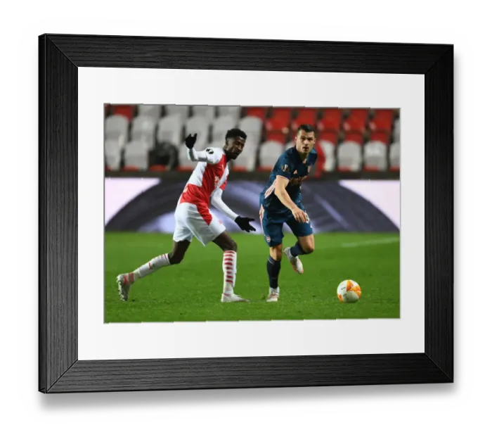 Framed Print : Arsenal's Granit Xhaka Faces Off Against Slavia Praha's Peter Olayinka in Europa League Quarterfinal: Prague Showdown
