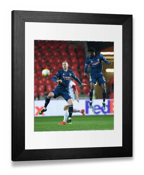 Framed Print : Arsenal's Holding and Partey in Quiet Eden Arena: Arsenal FC vs Slavia Praha, UEFA Europa League Quarterfinal (Behind Closed Doors) Framed Print : Arsenal's Holding and Partey in Quiet Eden Arena: Arsenal FC vs Slavia Praha, UEFA Europa League Quarterfinal (Behind Closed Doors)