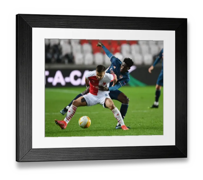 Framed Print : Thomas Partey vs. Ondrej Lingr: Arsenal's Europa League Battle at Empty Eden Arena vs. Slavia Prague Framed Print : Thomas Partey vs. Ondrej Lingr: Arsenal's Europa League Battle at Empty Eden Arena vs. Slavia Prague