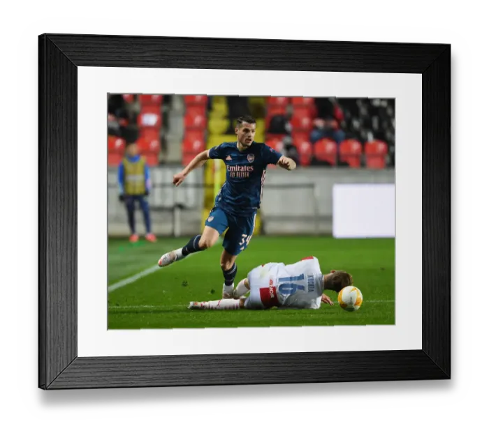 Framed Print : Xhaka vs. Kuchta: Prague Showdown - Arsenal's Granit Xhaka Clashes with Slavia Praha's Jan Kuchta in UEFA Europa League Quarterfinal